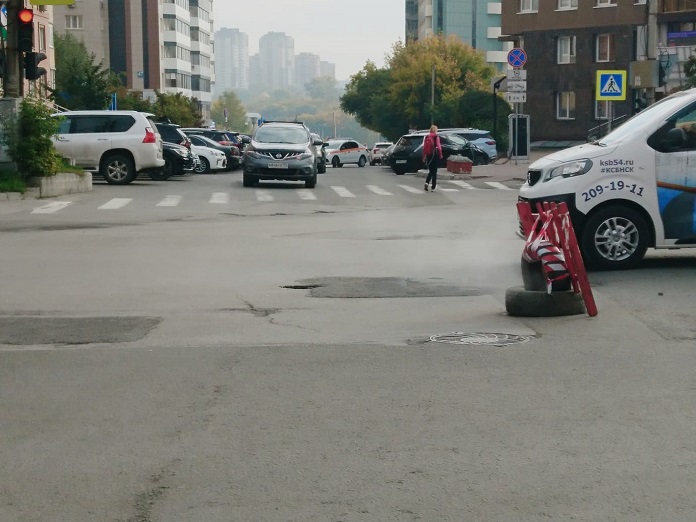 «Небольшой дефект теплотрассы»: парящий провал в асфальте на новосибирской улице Орджоникидзе обещают ликвидировать на следующей неделе